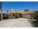 Charming home featuring a barrel tile roof, brick facade, well-manicured lawn and spacious driveway at 301 Waterwood Dr, Yalaha, FL 34797