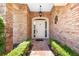 Inviting front entrance featuring a brick walkway, brick walls, and a classic white door at 301 Waterwood Dr, Yalaha, FL 34797