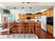 Spacious kitchen with wooden cabinets, a large island, and barstool seating at 301 Waterwood Dr, Yalaha, FL 34797