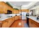 Well-equipped kitchen with oak cabinets, white countertops, and modern appliances at 301 Waterwood Dr, Yalaha, FL 34797