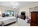 Inviting bedroom with sliding glass doors leading to the outside, providing a stunning view of the surrounding nature at 301 Waterwood Dr, Yalaha, FL 34797