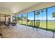 Relax on the screened patio with tile floors, ceiling fan and waterfront views of the clear blue lake at 301 Waterwood Dr, Yalaha, FL 34797