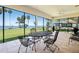 Enjoy waterfront views on the screened patio with tile floors, ceiling fan and metal table and chairs at 301 Waterwood Dr, Yalaha, FL 34797