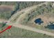 Aerial view of neighborhood intersection with a large stormwater pond at 30554 Quince Ave, Eustis, FL 32736
