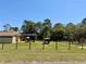 View of the house from across the yard showing screen lanai and equipment shed at 30554 Quince Ave, Eustis, FL 32736