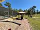 Paver patio with gazebo and barbecue grill adjacent to a screened-in pool in a spacious backyard at 30554 Quince Ave, Eustis, FL 32736