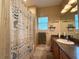Comfortable bathroom with a single sink vanity, tiled floors and charming shower curtain at 30554 Quince Ave, Eustis, FL 32736
