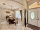Bright dining area featuring a modern chandelier, a rustic dining table, and elegant curtains at 30554 Quince Ave, Eustis, FL 32736