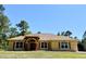 Charming home boasts a well-manicured lawn, beautiful roof, and a welcoming double-door entrance at 30554 Quince Ave, Eustis, FL 32736