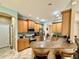 Well-lit kitchen featuring wood cabinets, stainless steel appliances, and a breakfast bar area at 30554 Quince Ave, Eustis, FL 32736