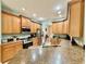 Spacious kitchen with wood cabinets, stainless steel appliances, and ample countertop space at 30554 Quince Ave, Eustis, FL 32736