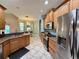 Functional kitchen with stainless steel appliances, wood cabinets, and breakfast bar at 30554 Quince Ave, Eustis, FL 32736