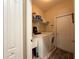 Functional laundry room equipped with a washer, dryer, and a utility sink at 30554 Quince Ave, Eustis, FL 32736