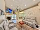 Open living room with tile floors, a fireplace, and neutral décor, perfect for relaxing and entertaining at 30554 Quince Ave, Eustis, FL 32736