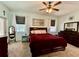 Relaxing main bedroom with a ceiling fan, two windows, and dark wood furnishings at 30554 Quince Ave, Eustis, FL 32736