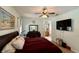 Comfortable main bedroom featuring a ceiling fan, a large dresser, and an ensuite bathroom at 30554 Quince Ave, Eustis, FL 32736