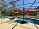 Screened-in pool featuring built in seating and fountain at 30554 Quince Ave, Eustis, FL 32736