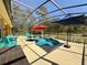 Screened in pool with fountain and outdoor dining and lounge areas at 30554 Quince Ave, Eustis, FL 32736