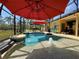 Lush screened-in pool area with an inground pool, water features, and backyard view at 30554 Quince Ave, Eustis, FL 32736