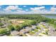 Stunning aerial view of a residential community near baseball fields, lush greenery, and a tranquil lake at 31799 Broadwater Ave, Leesburg, FL 34748