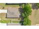 An aerial view of the home showcases the roof, yard, and proximity to neighboring houses at 31799 Broadwater Ave, Leesburg, FL 34748