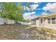 Expansive backyard featuring a white fence, complemented by lush trees and a cozy patio area with outdoor seating at 31799 Broadwater Ave, Leesburg, FL 34748