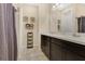 Bathroom features double sinks with dark cabinets, neutral paint and tiled floors at 31799 Broadwater Ave, Leesburg, FL 34748