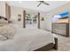 Comfortable bedroom with a large window, ceiling fan, and dresser with TV at 31799 Broadwater Ave, Leesburg, FL 34748