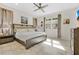 Tranquil bedroom features a ceiling fan, large window, and neutral decor at 31799 Broadwater Ave, Leesburg, FL 34748
