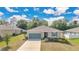 Charming single-story home features a well-maintained lawn, inviting entrance, and a two-car garage at 31799 Broadwater Ave, Leesburg, FL 34748