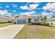 Charming single-story home with a well-maintained lawn, complemented by a two-car garage and vibrant green shrubbery at 31799 Broadwater Ave, Leesburg, FL 34748