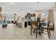 Open-concept layout with kitchen island, modern stainless appliances, adjacent dining area with stylish lighting at 31799 Broadwater Ave, Leesburg, FL 34748