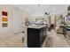 Bright and airy kitchen featuring an island with seating, stainless appliances, and an open floor plan at 31799 Broadwater Ave, Leesburg, FL 34748