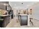 Modern kitchen features stainless appliances, dark cabinets, and a breakfast bar with seating at 31799 Broadwater Ave, Leesburg, FL 34748