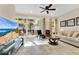 Bright living room with sliding glass doors leading to outdoor area, stylish decor and neutral color palette at 31799 Broadwater Ave, Leesburg, FL 34748