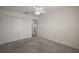 Spacious bedroom with plush carpeting and a walk-in closet for ample storage at 3305 Dzuro Dr, Oxford, FL 34484