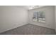 Bright bedroom with a window and neutral carpet perfect for customization at 3305 Dzuro Dr, Oxford, FL 34484