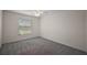 Cozy bedroom with neutral carpet, a window with blinds, and ample natural light at 3305 Dzuro Dr, Oxford, FL 34484