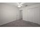 Neutral carpeted bedroom with ceiling fan and closet at 3305 Dzuro Dr, Oxford, FL 34484