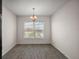 Cozy dining area featuring modern chandelier and natural light from a large window at 3305 Dzuro Dr, Oxford, FL 34484