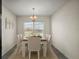 Bright dining area with stylish furnishings, including a wooden table and plush chairs at 3305 Dzuro Dr, Oxford, FL 34484