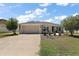 Charming single-story home featuring a well-manicured lawn and a two-car garage with concrete driveway at 3305 Dzuro Dr, Oxford, FL 34484