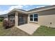 Rear view of the home exterior with screened lanai and patio at 3305 Dzuro Dr, Oxford, FL 34484