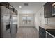 Bright kitchen features stainless steel appliances, dark cabinetry, and an adjacent dining area at 3305 Dzuro Dr, Oxford, FL 34484