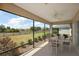 Screened lanai features an idyllic view and patio seating at 3305 Dzuro Dr, Oxford, FL 34484