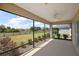 Enjoy peaceful views from this screened lanai with a ceiling fan at 3305 Dzuro Dr, Oxford, FL 34484