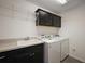 Well-equipped laundry room with modern appliances and ample storage at 3305 Dzuro Dr, Oxford, FL 34484