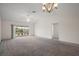 Open floor plan featuring a living room with slider doors to the backyard at 3305 Dzuro Dr, Oxford, FL 34484