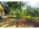 Backyard landscaped with a banana tree and lush tropical plants at 333 Stanley Bell Dr, Mount Dora, FL 32757