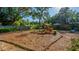 Spacious, tree-lined backyard, covered with mulch, and featuring landscaping at 333 Stanley Bell Dr, Mount Dora, FL 32757